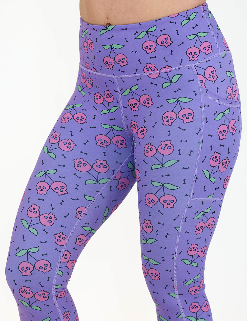 front of the skull cherry print leggings against a white background