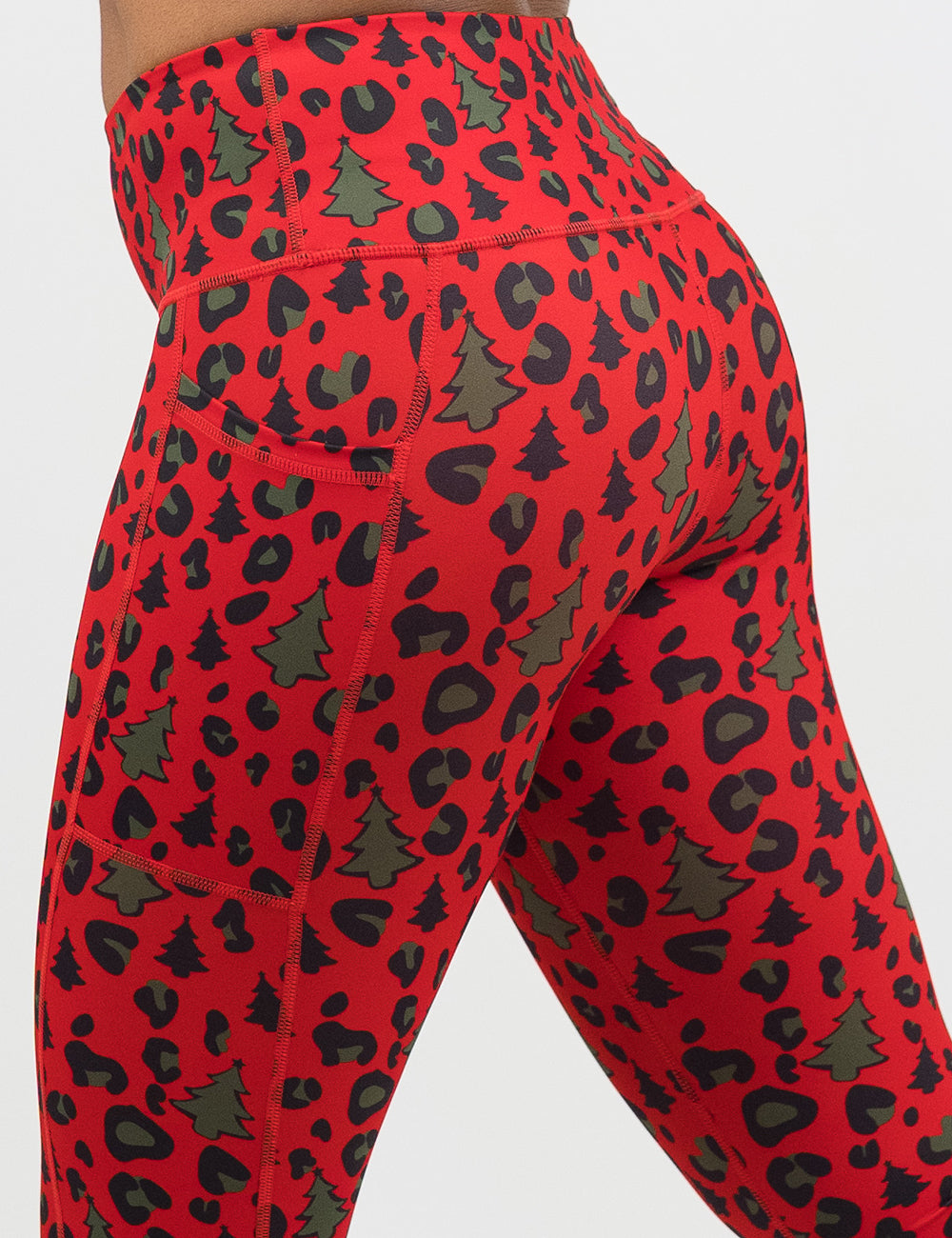 close up of the back of the red and brown Christmas trees and leopard print leggings against a white background