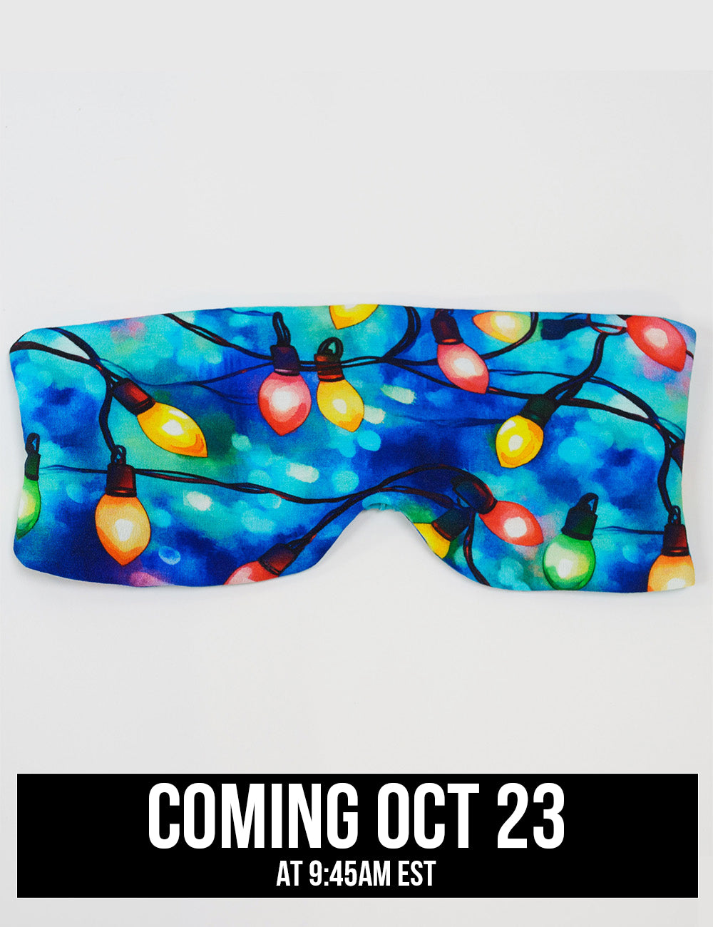 front of the Christmas lights in front of blue and teal background eye mask, coming October 23