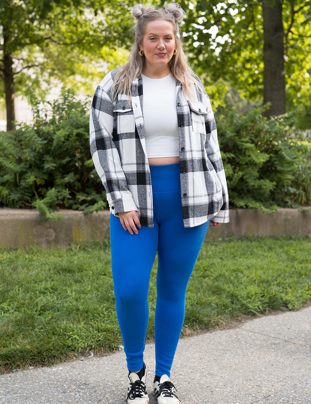 model wearing the solid blue fleece lined leggings and a black shacket