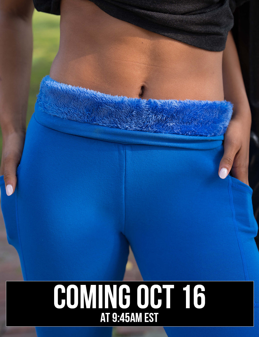 close up of the solid blue fleece lined leggings being rolled down to show the fleece lined interior, coming October 16th