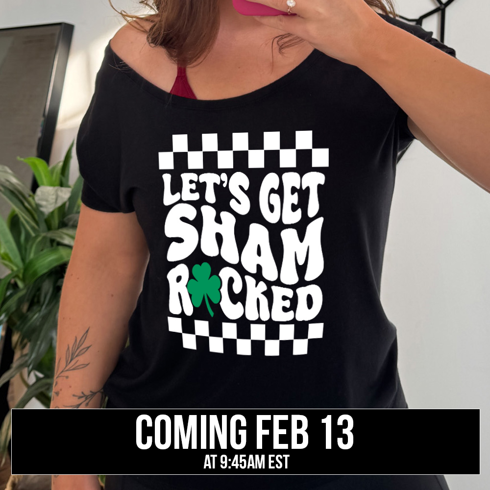 black slouchy tee with the words "let's get shamrocked" on it, with a shamrock graphic replacing the "o" of "rocked", and a checkerboard border on top and bottom of the words, coming soon