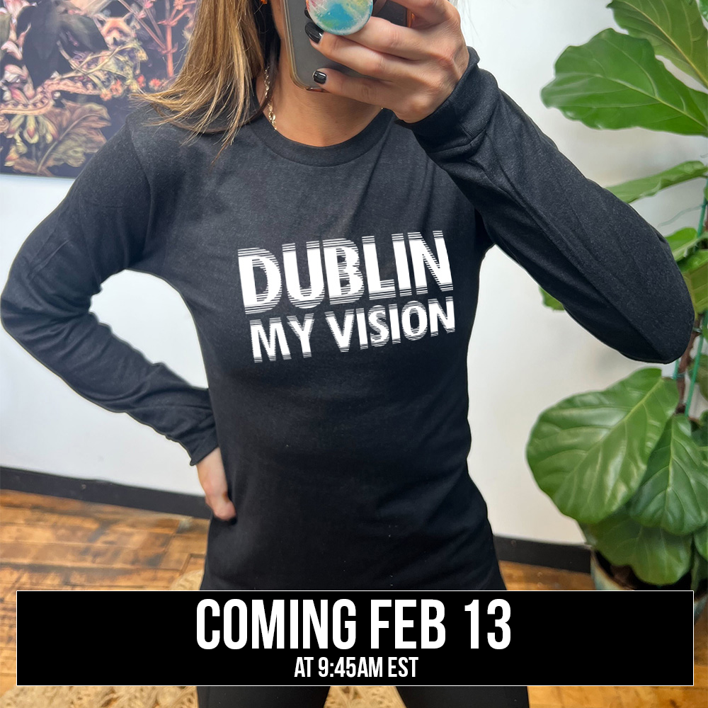 heather black long sleeve with the words "dublin my vision" on it, displayed in a way to cause the optical illusion of blurred, doubled vision, coming soon