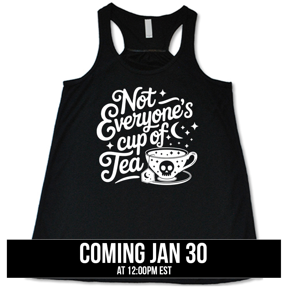 black flowy tank with the words "not everyone's cup of a tea" in a cursive font, with the graphics of a moon and little stars, and a tea cup with a skull on it with stars and the tea bag has a moon on it, coming soon