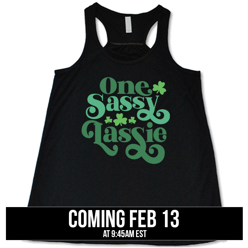 black flowy tank with the words "one sassy lassie" on it, with a few shamrock graphics, coming soon