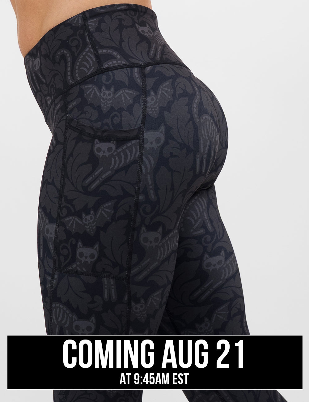 side view of the black and grey bats and cats skeletons leggings against a white background, coming august 21st