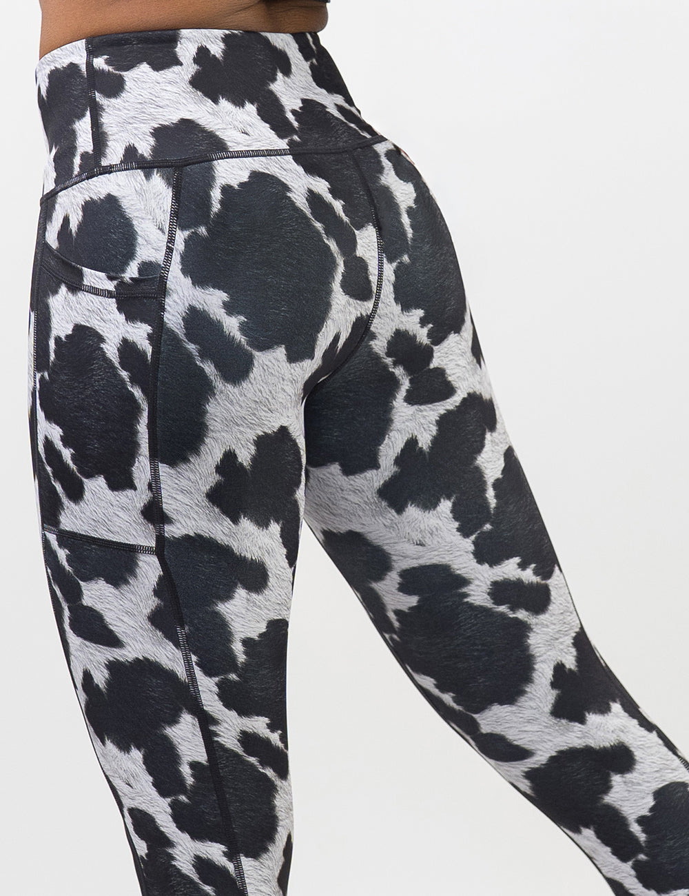 back of the cow print leggings against a white background