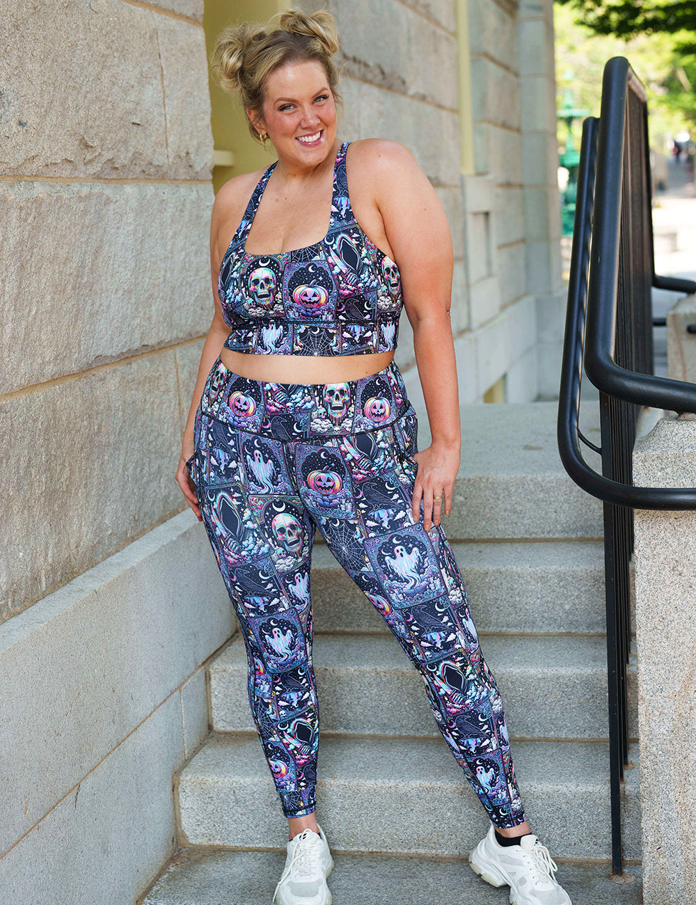 model wearing the rainbow skulls, jack o lantern, and ghosts full length leggings and bra