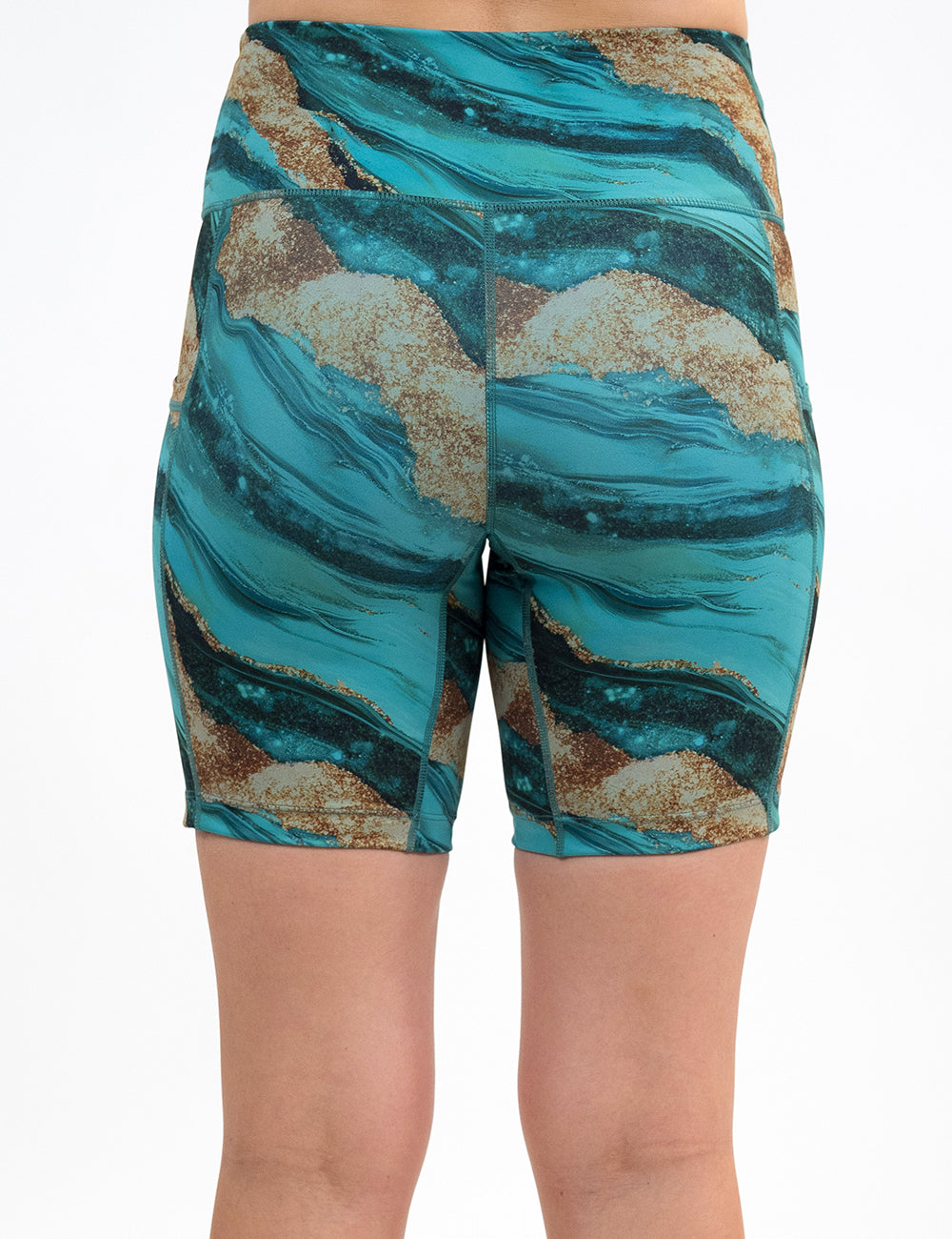 back of the 7 inch blue ocean with gold streaks patterned shorts against a white background