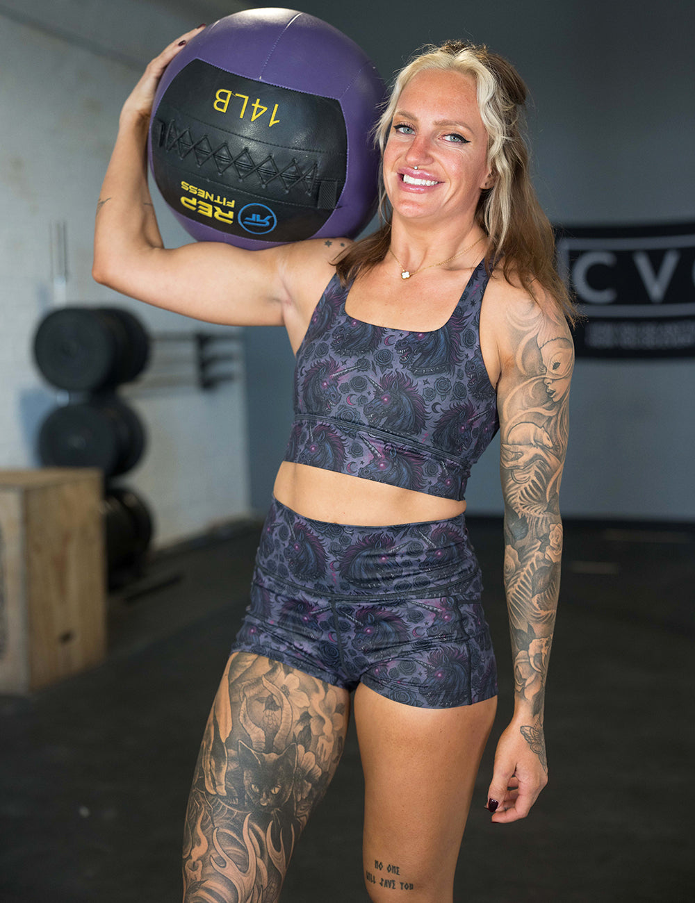 model wearing the 2.5 inch dark unicorn shorts in the gym holding a medicine ball