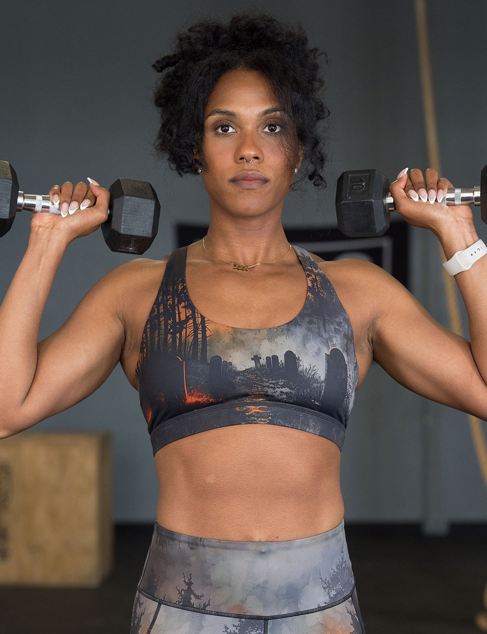 model wearing the dark cemetery with a full moon bra working out in the gym
