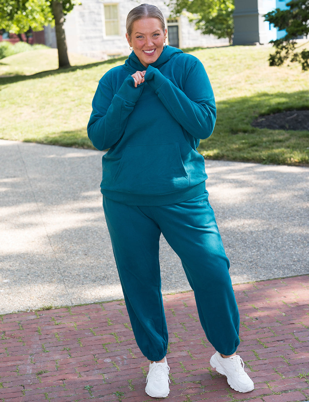 model wearing the dark blue matching sweat pants and hoodie sweatsuit