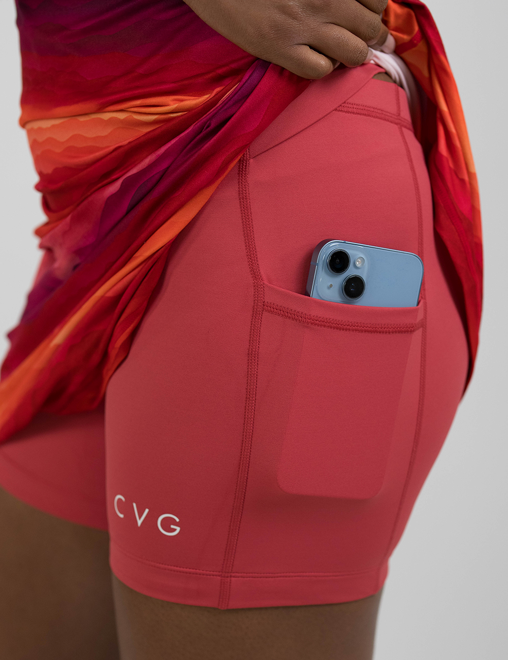 the sunrise dress pulled up to show the pockets underneath holding a phone