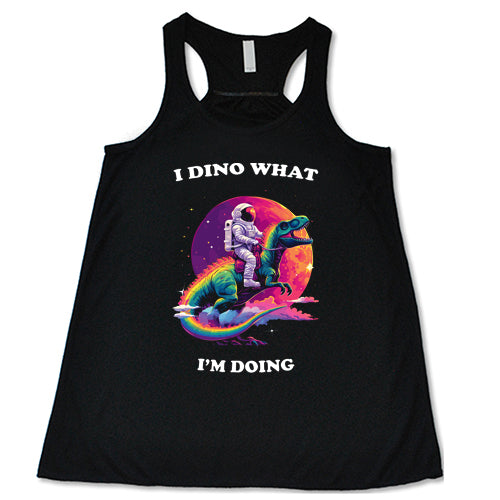 a black racerback shirt with a astronaut and dinosaur graphic with the quote "I Dino What I'm Doing" on it