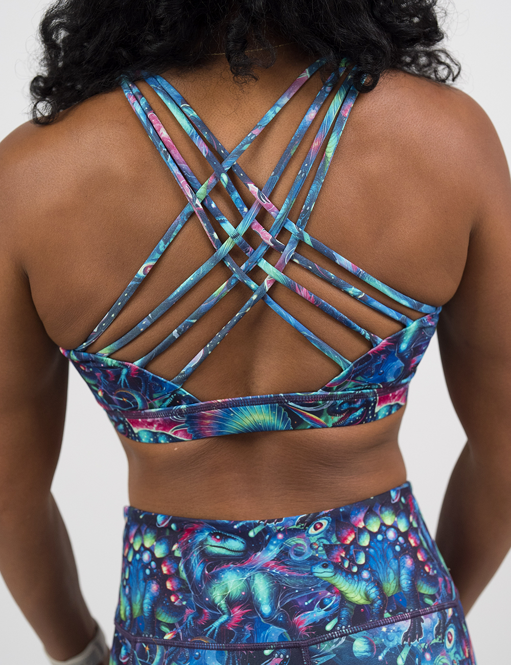 back of the colorful dinosaur pattern butterfly back bra against a white background