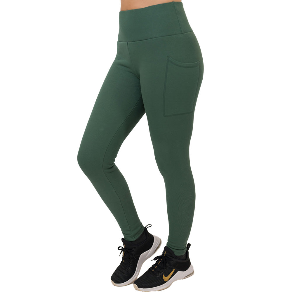 Green leggings with pockets worn by a person on a white background