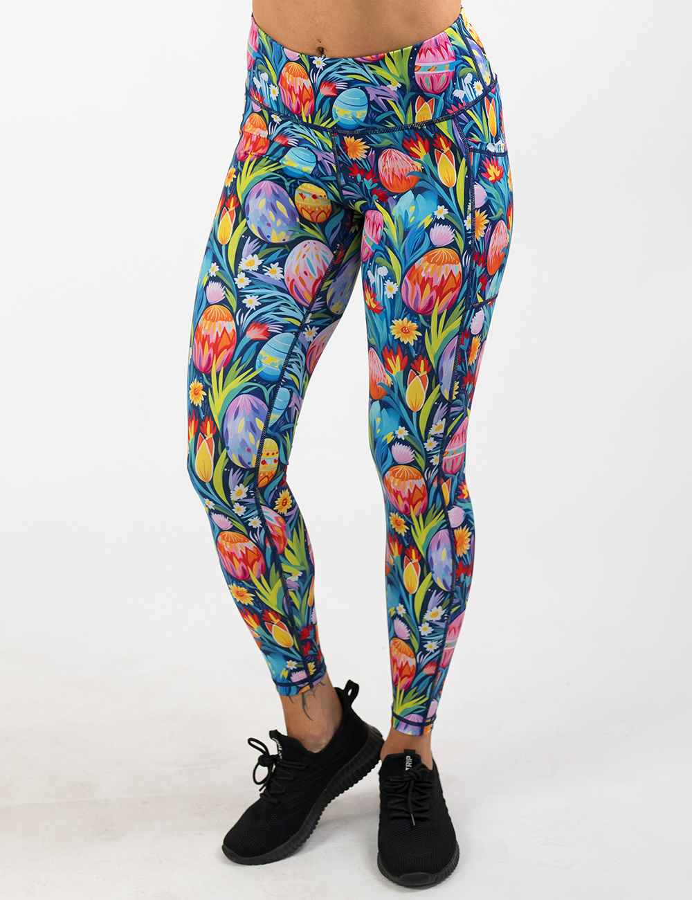 easter eggs in a field of flowers pattern full length leggings facing the front against a white background