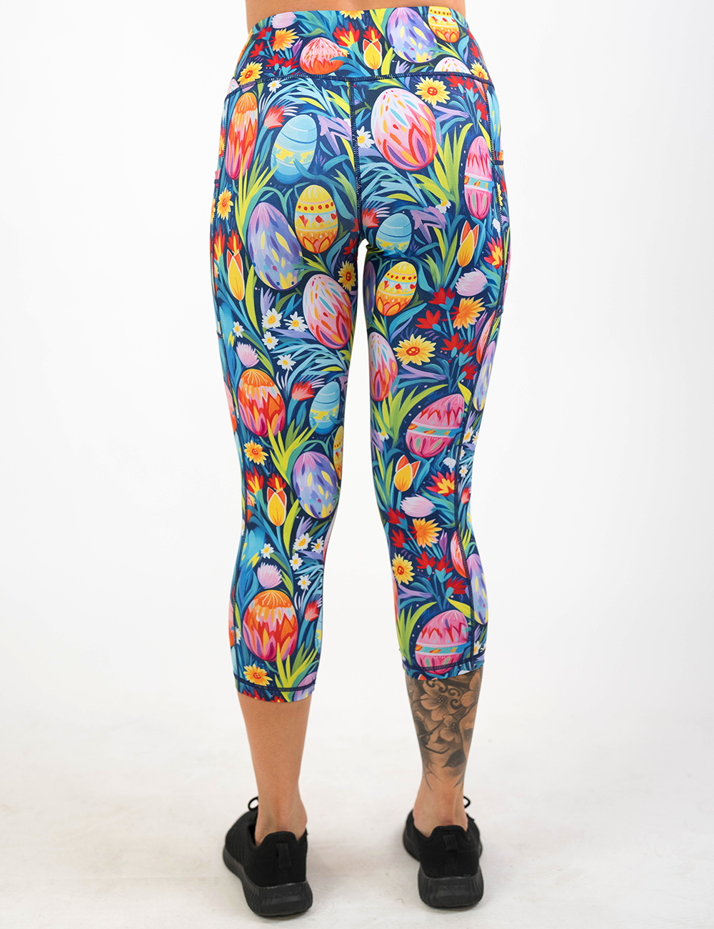 back of the easter eggs in a field of flowers pattern capri leggings against a white background