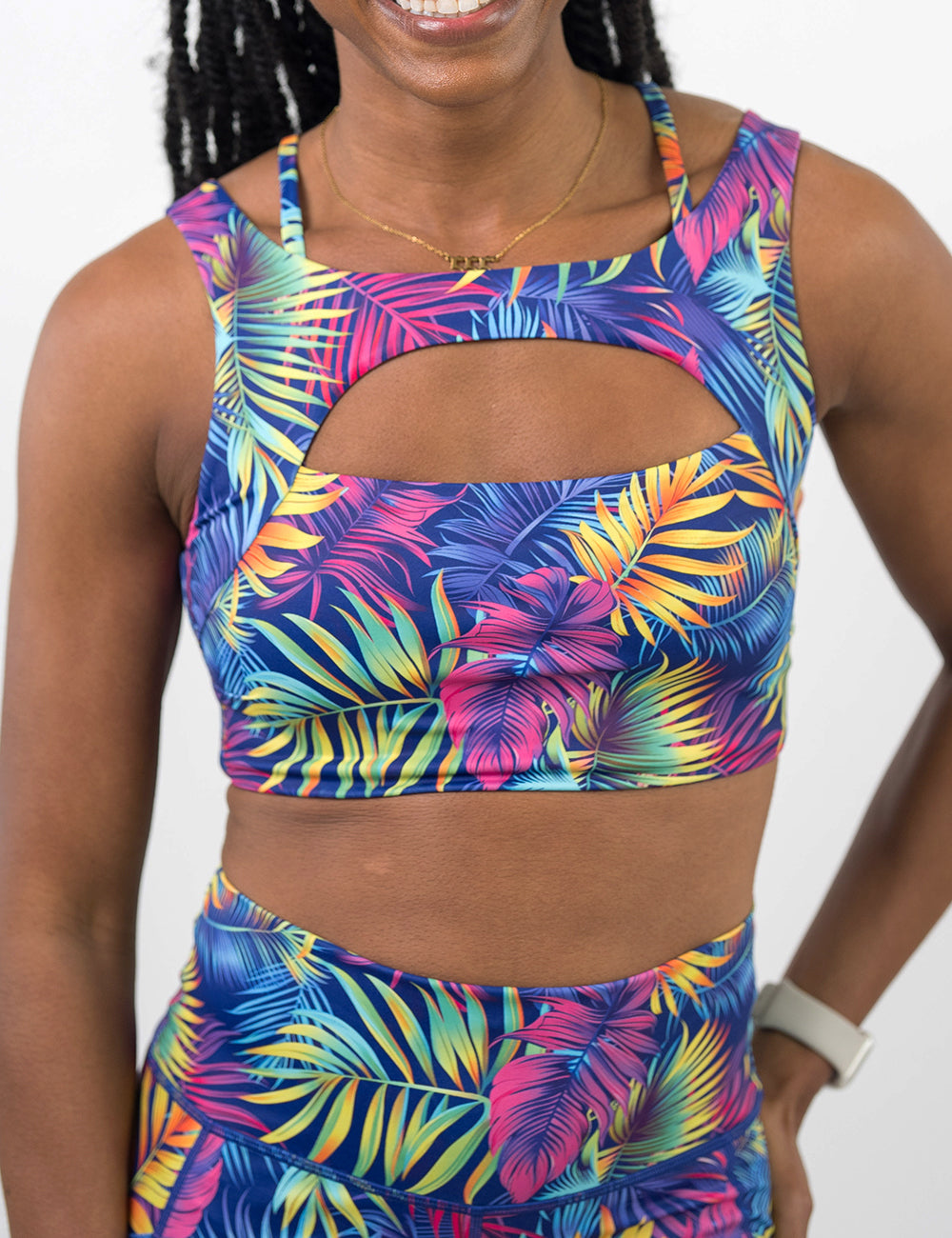 front of the vibrant tropical leaves vista bra against a white background