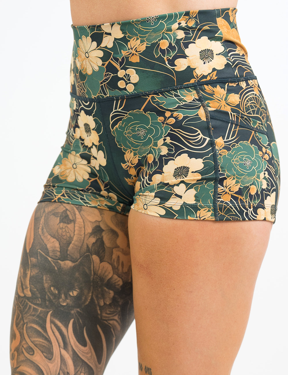front of the 2.5 inch green and gold flower with gold accent shorts