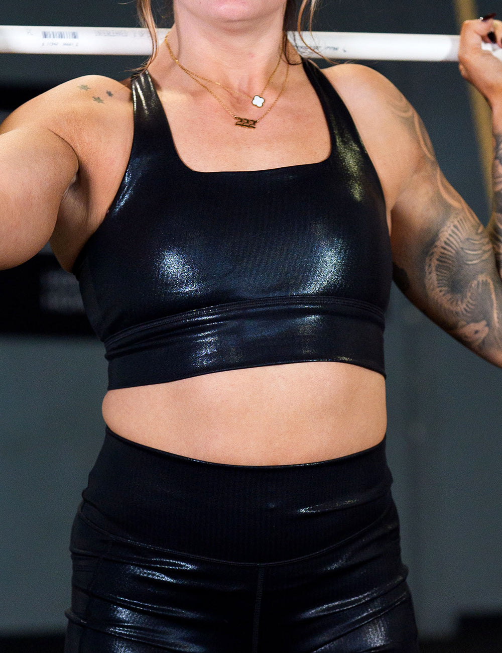 model wearing the black leather bra working out in the gym