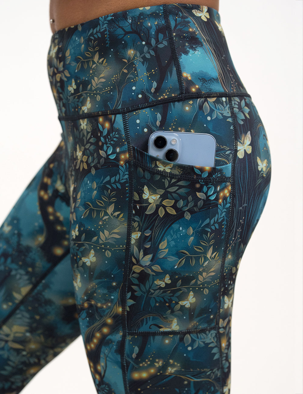 close up of the forest filled with firefly's pattern leggings with a phone in its pocket