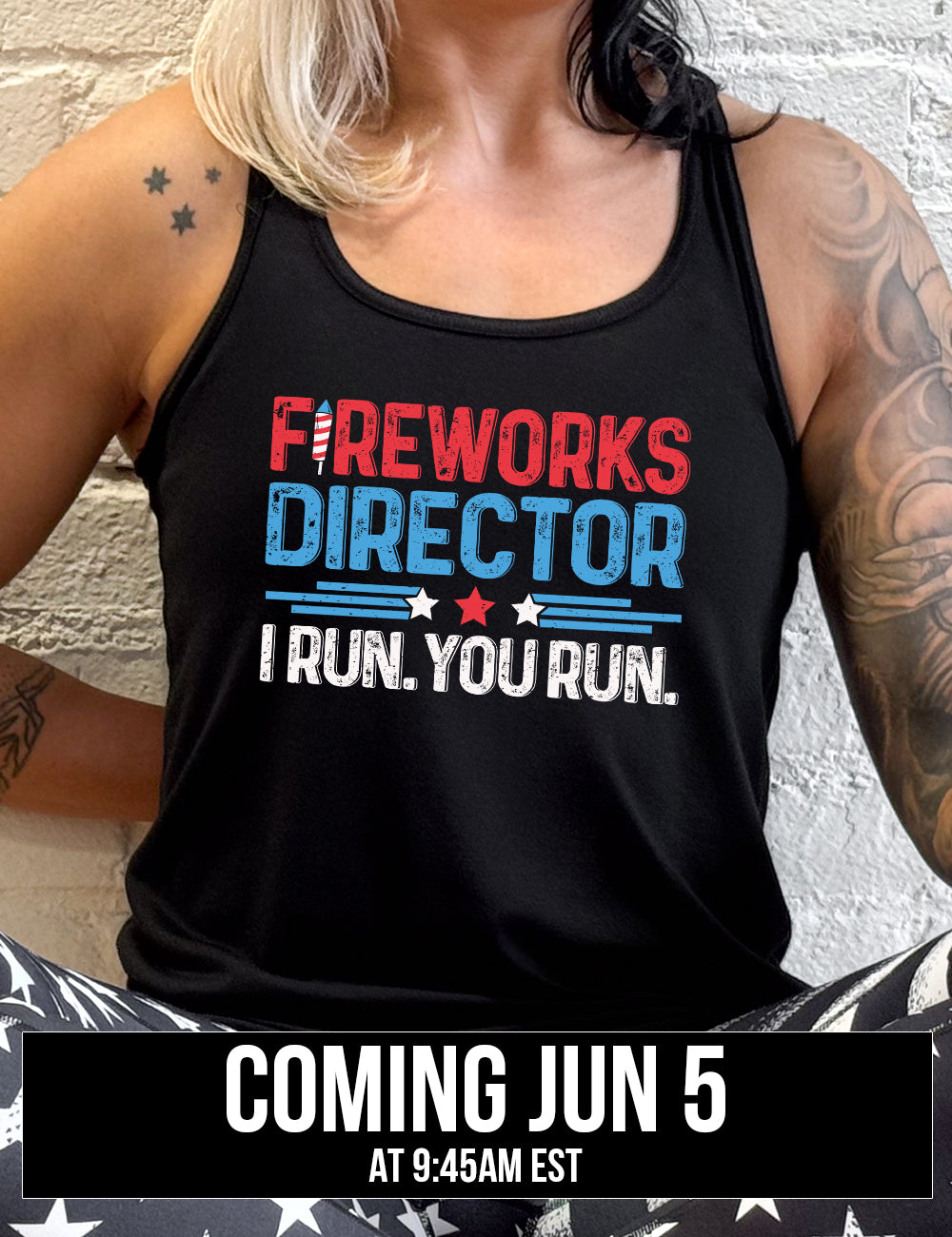 black flowy racerback tank with the words "Fireworks Director -- I run. You run." on it, with the "i" of "fireworks" in the shape of a firework, and some stripes with a few stars in between the word "director" and "I run. You run.", coming june 5th