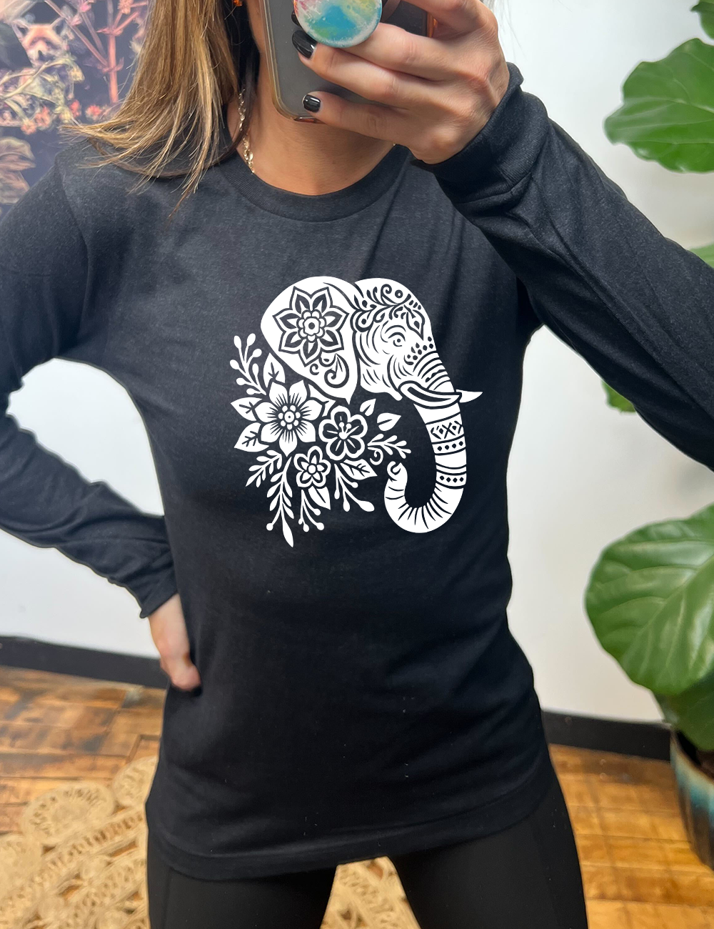 heather black long sleeve tee with the large graphic of the profile of an elephant's head, with flowers for a torso, and patterns lining its truck and flowers patterned into its ear and forehead