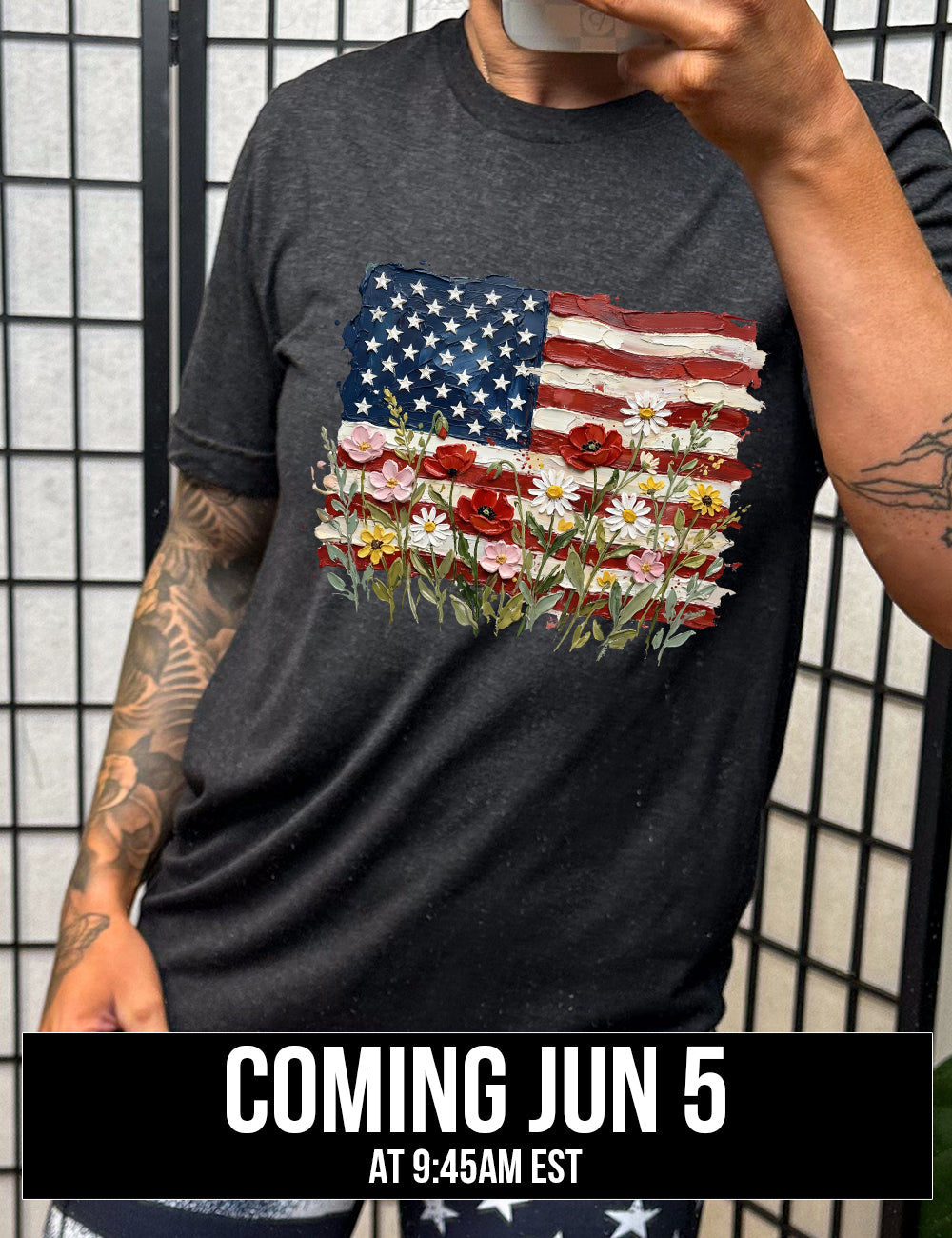 black unisex tee with the graphic of an American flag with flowers in front of it, with the style of the graphic looking made of oil paint, coming june 5th