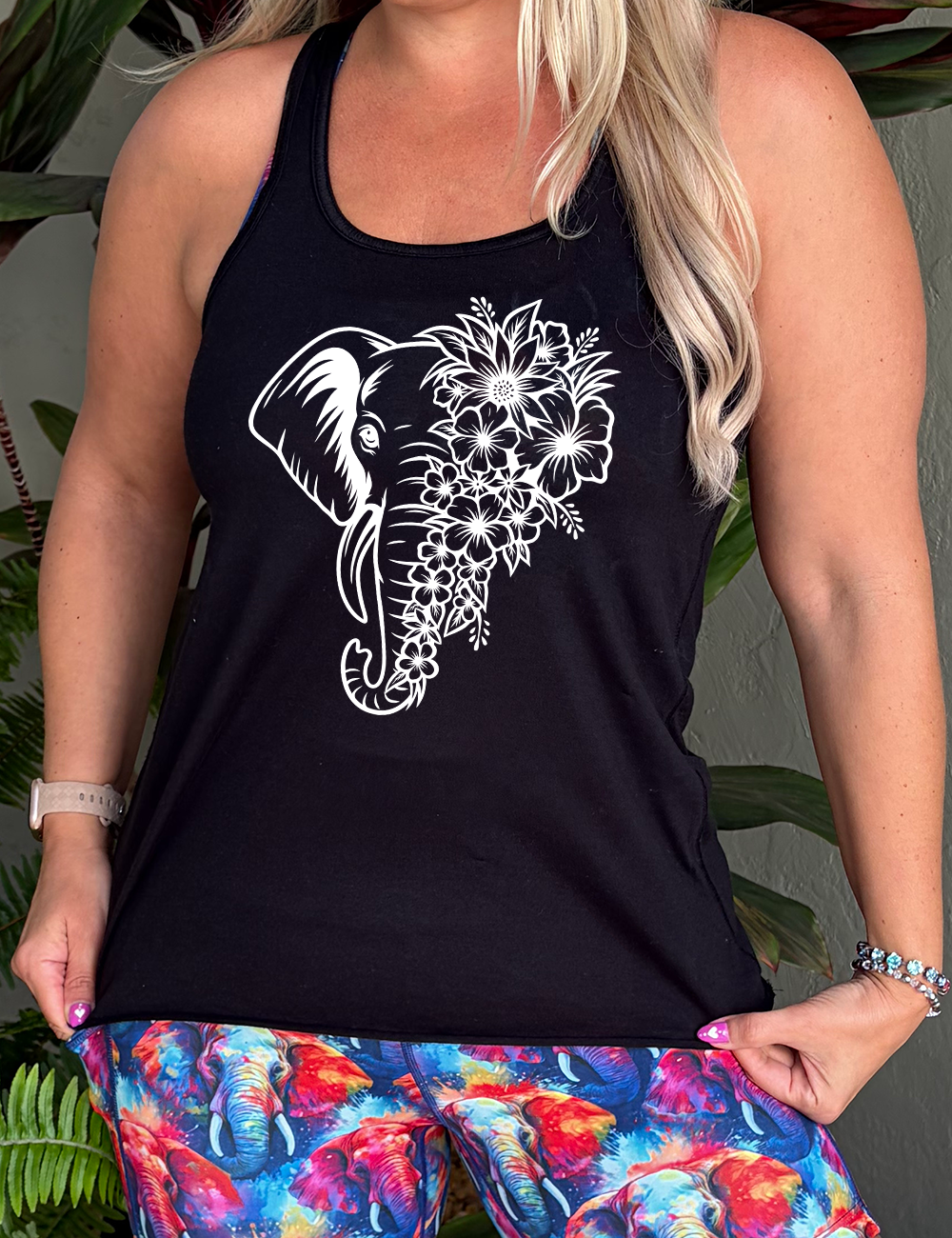 black racerback tank with the graphic of an elephant's head, with half of its head made up only of tropical flowers