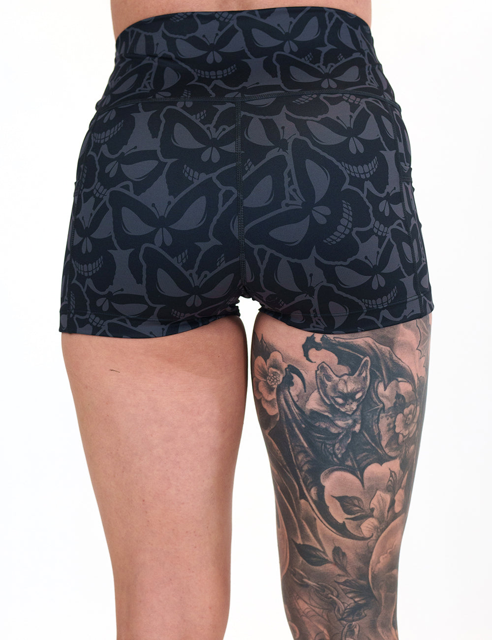 back of the 2.5 inch grey and black butterfly shaped skulls patterned shorts against a white background