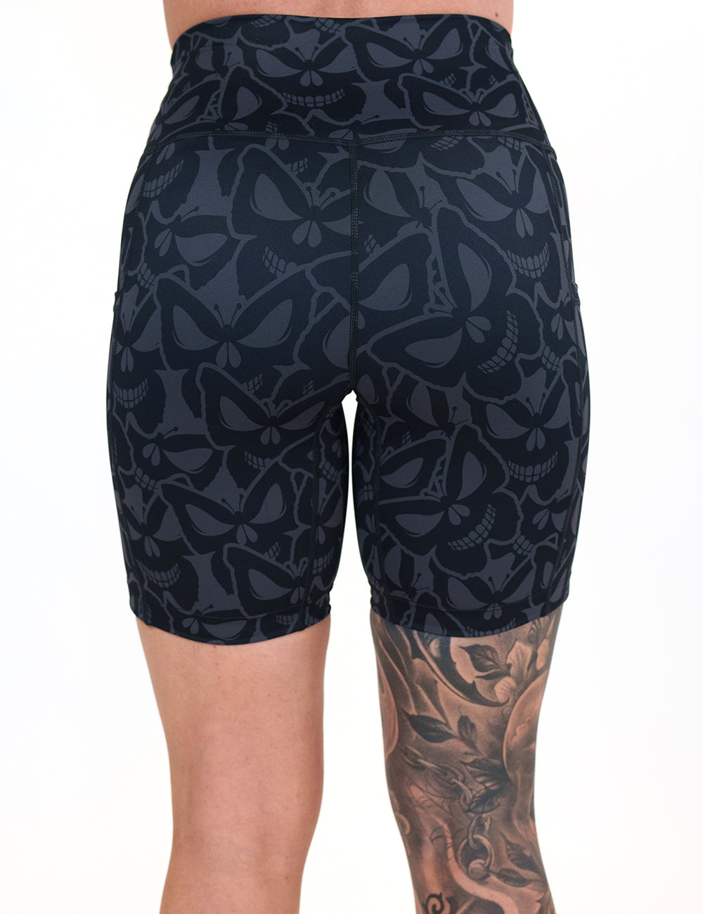 back of the 7 inch grey and black butterfly shaped skulls patterned shorts against a white background