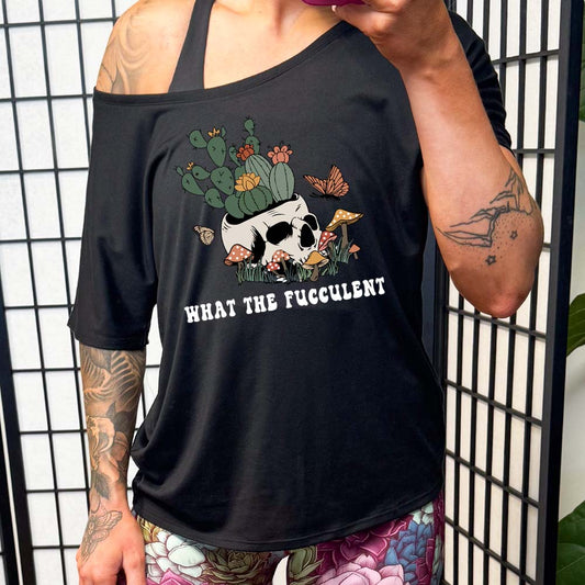model wearing the black slouchy shirt with a plant graphic with the saying "what the fucculent" on it in white