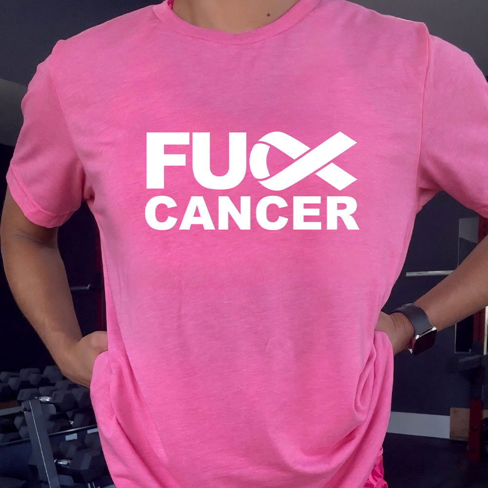 Person wearing a pink t-shirt with 'FU Cancer' text in a gym setting