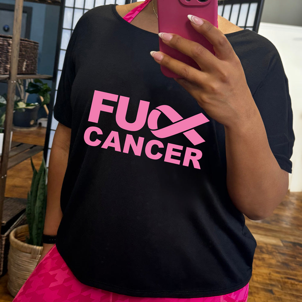 Person wearing a black t-shirt with 'FU Cancer' in pink text, taking a mirror selfie