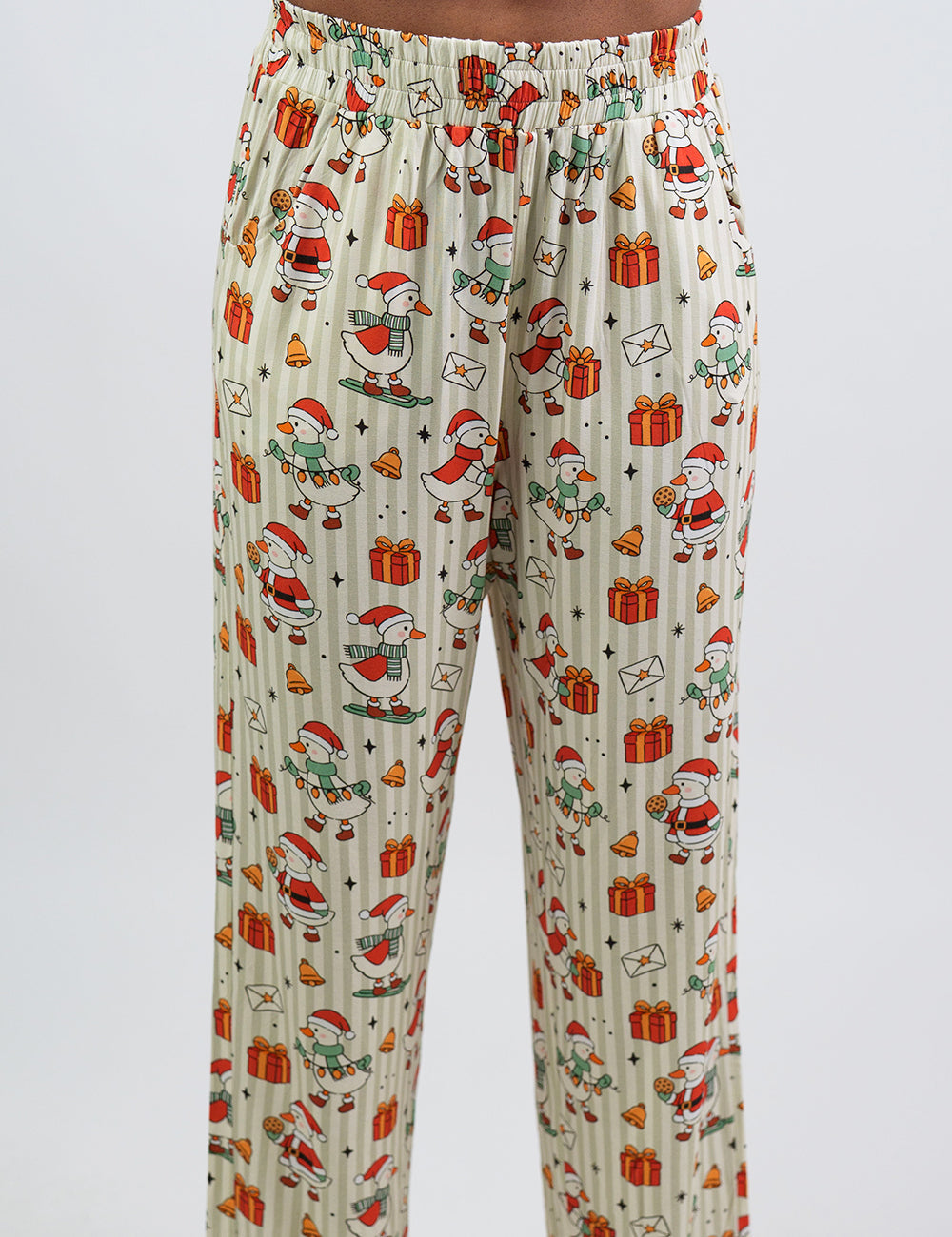 close up of the ducks with santa hats surrounded by presents striped pajama bottoms