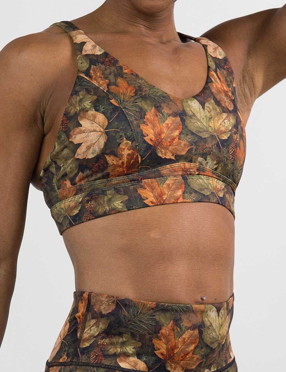 front of the forest floor covered in leaves bra against a white background