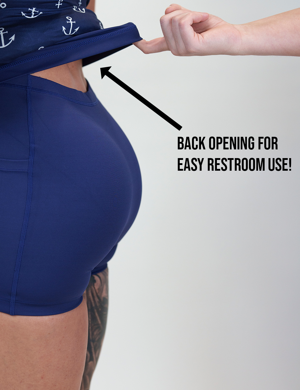 back of the blue dress with white anchors held up to show the easy restroom use back opening