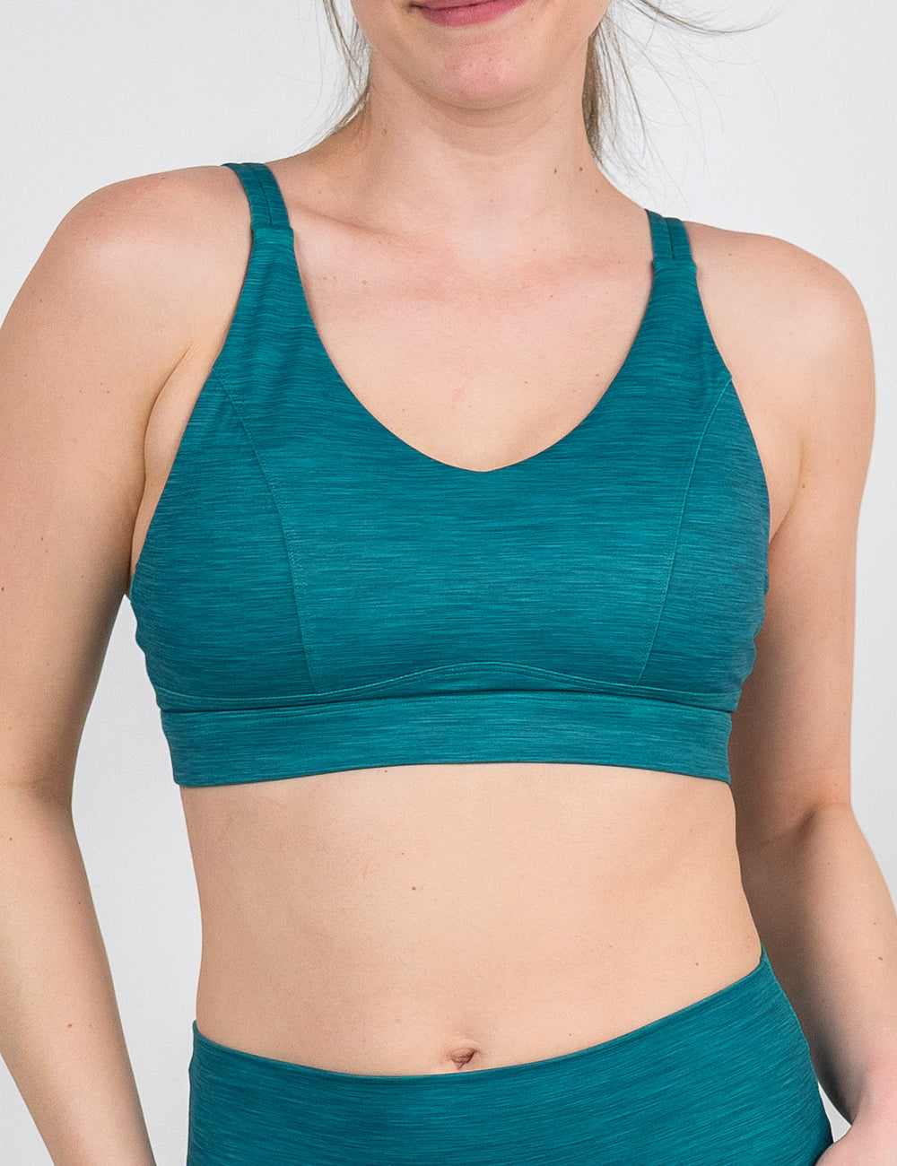 front of the teal green heather pattern vitality bra against a white background
