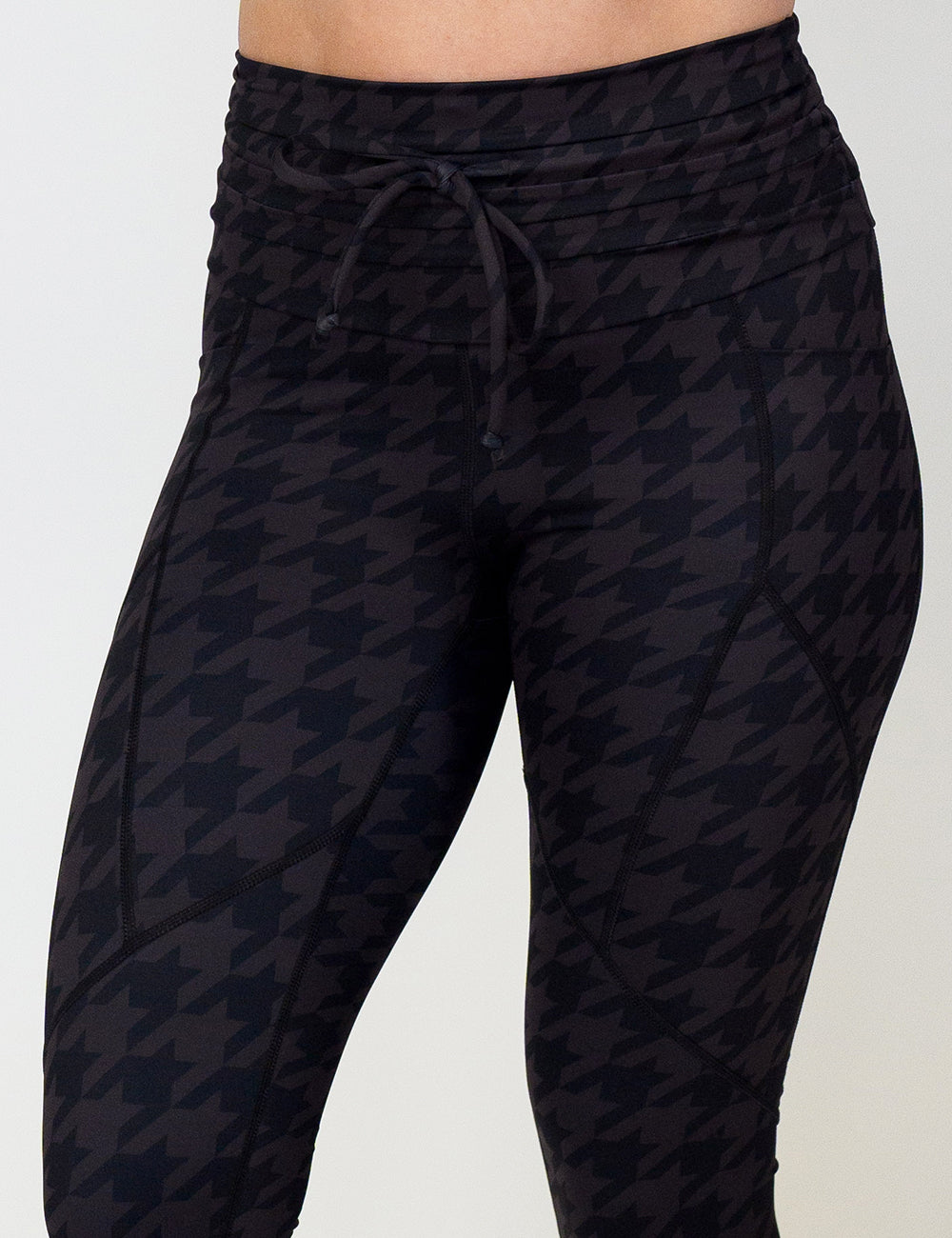 houndstooth patterned leggings against a white background