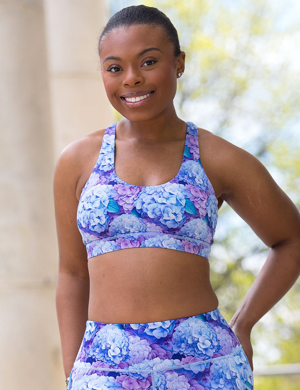 model wearing the blue and purple pastel hydrangea flower bra and leggings
