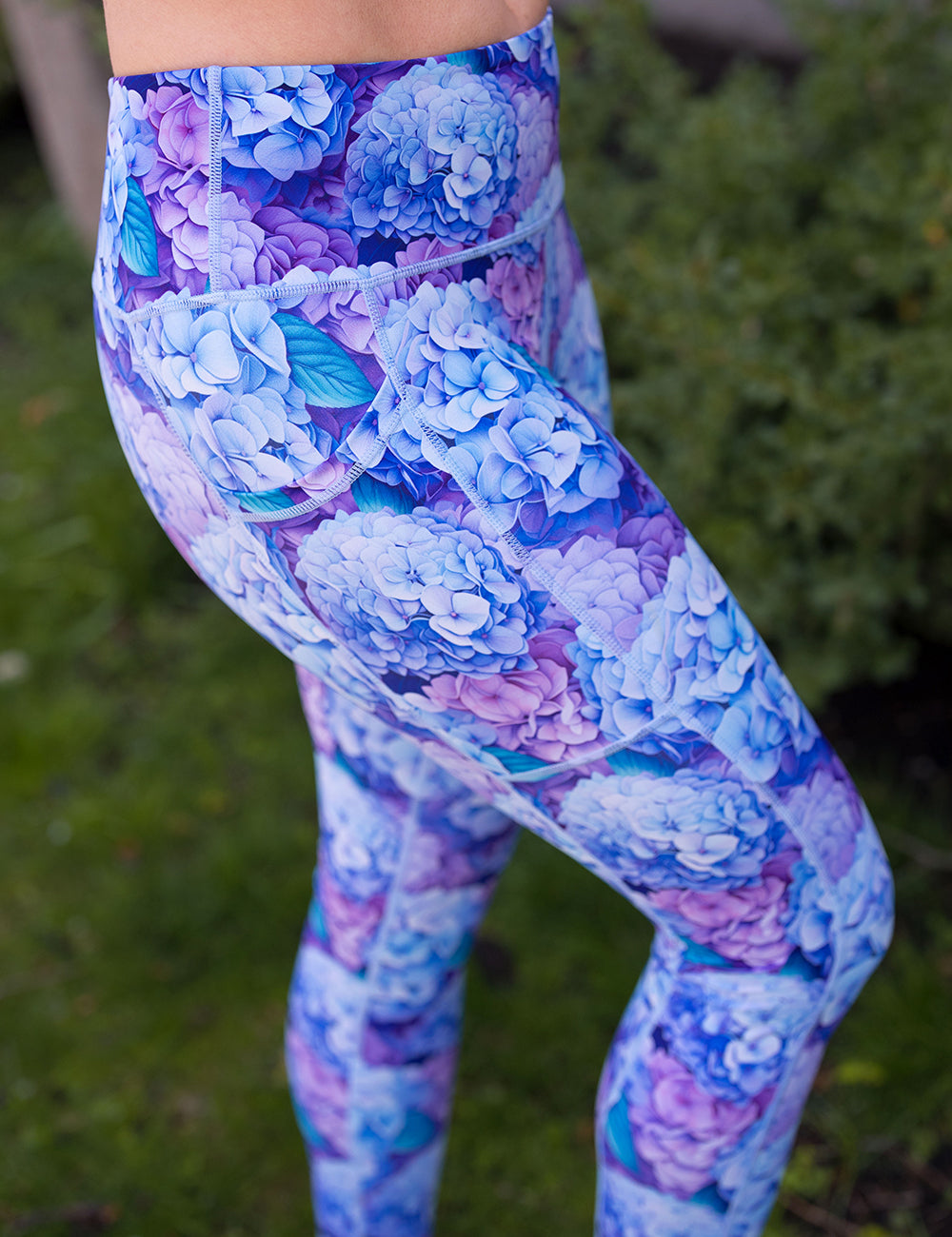 front of the blue and purple pastel hydrangea flowers leggings