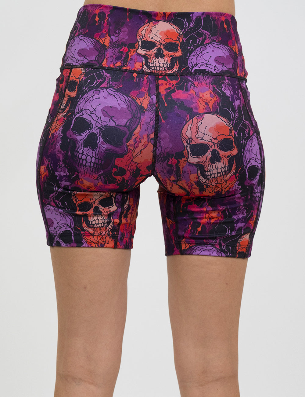 back of the 7 inch purple and orange skull patterned shorts against a white background