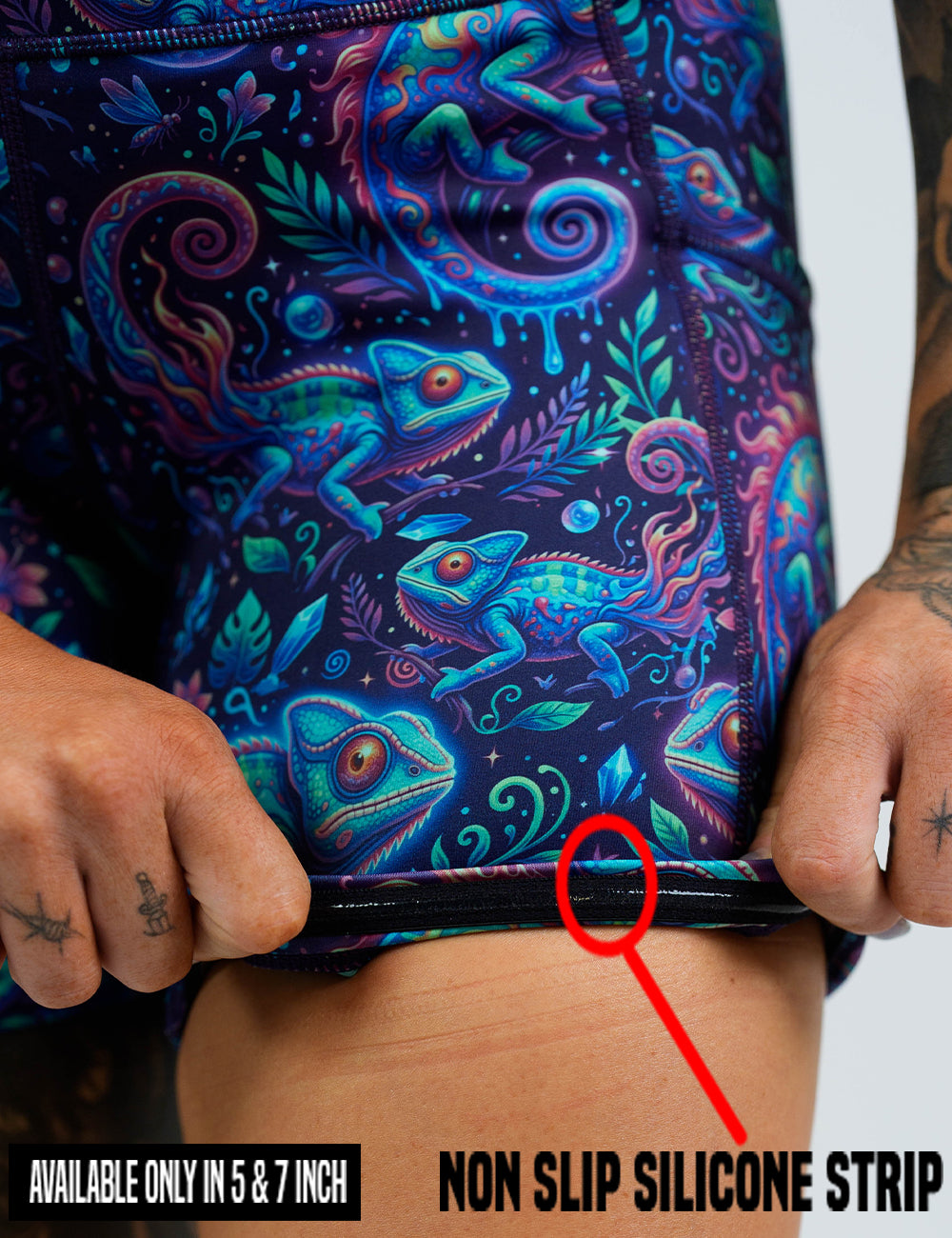 close up of the orange, blue, and red chameleons surrounded by plants shorts being rolled up to show the non slip silicone strip found in the 5 and 7 inch inseam sizes