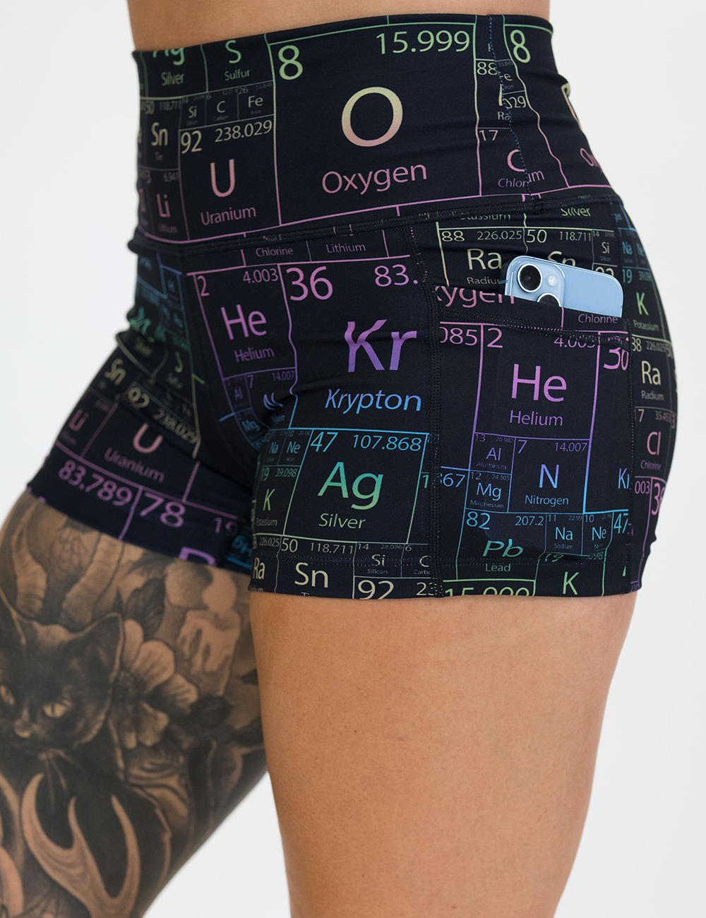 close up of the 2.5 inch black periodic table shorts with a phone in its pocket