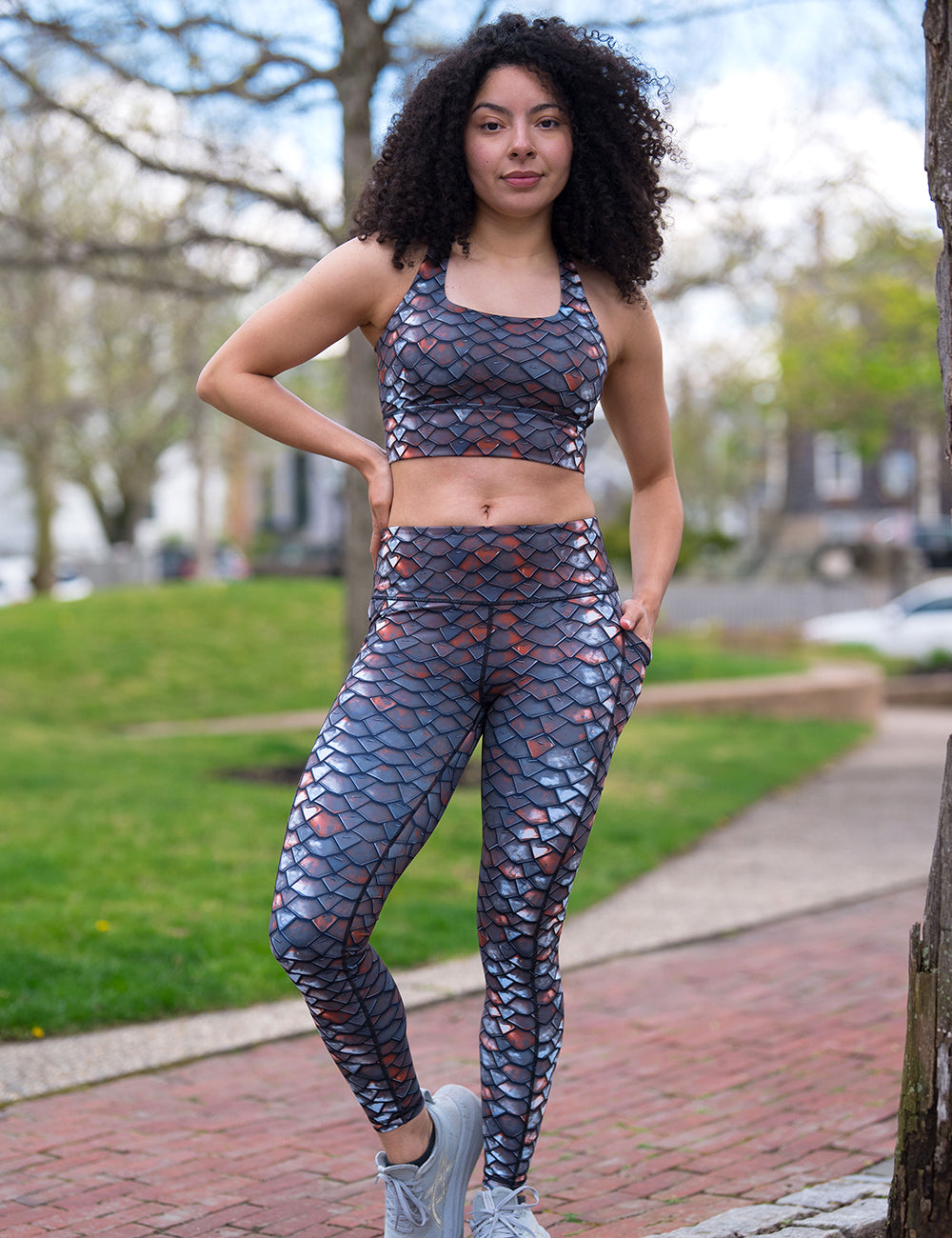 model wearing the full length iron sheet pattern leggings and bra outside in a park