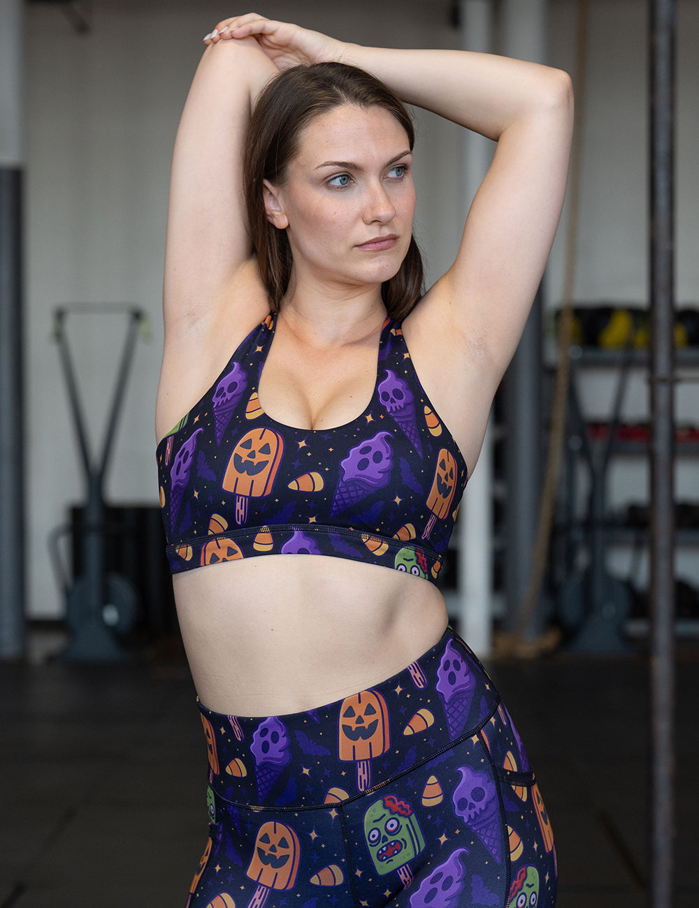 model wearing the zombie, jack o lantern, and ghost ice cream's sports bra and leggings in the gym
