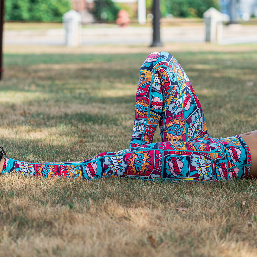 model laying in the grass wearing knockout leggings