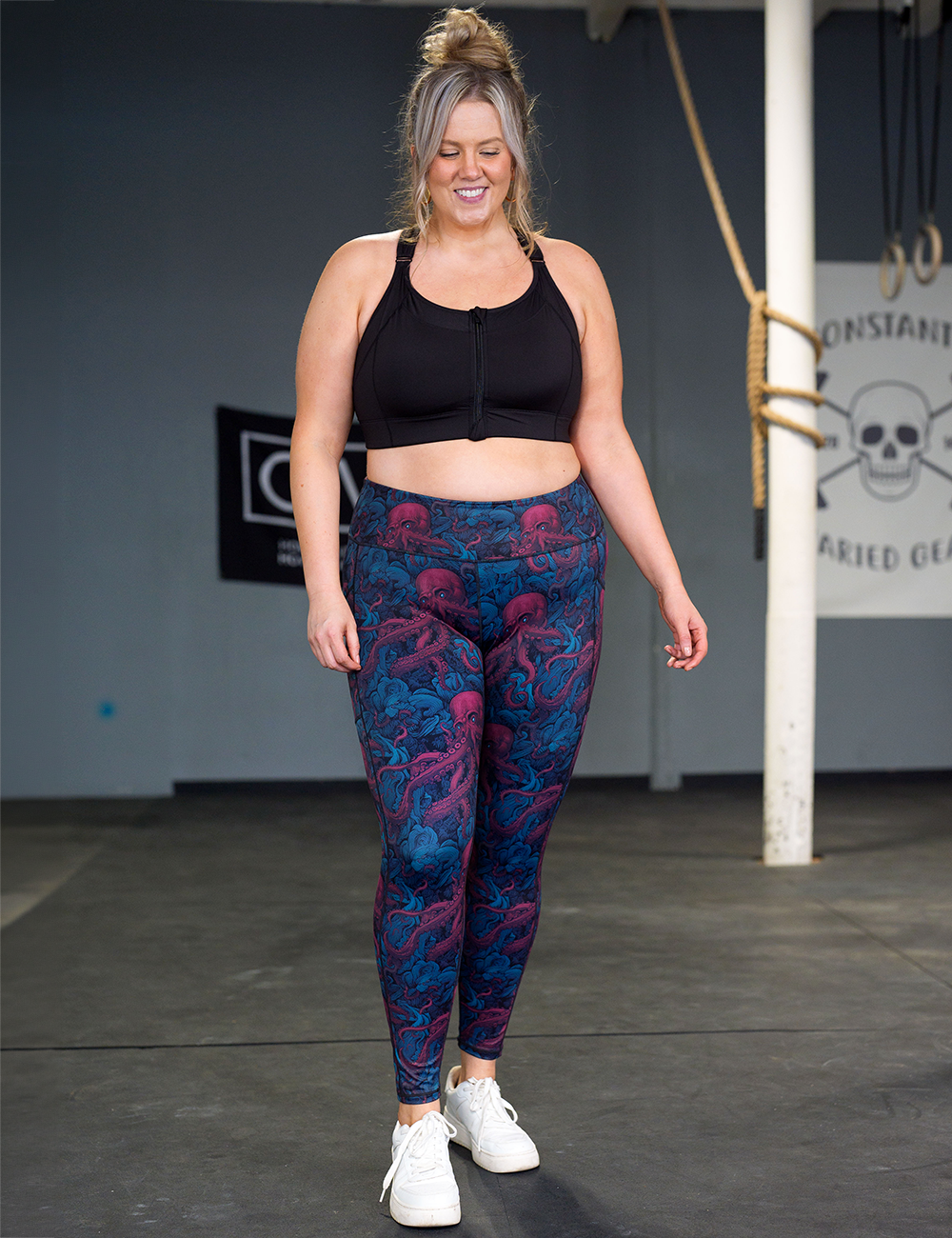 model wearing the full length maroon octopus leggings in the gym