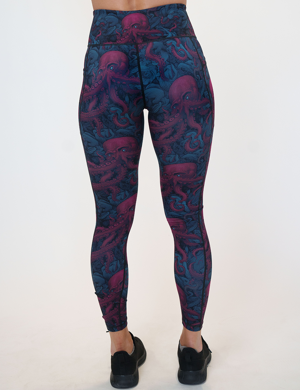 back of the maroon octopus with glowing blue eyes full length leggings against a white background